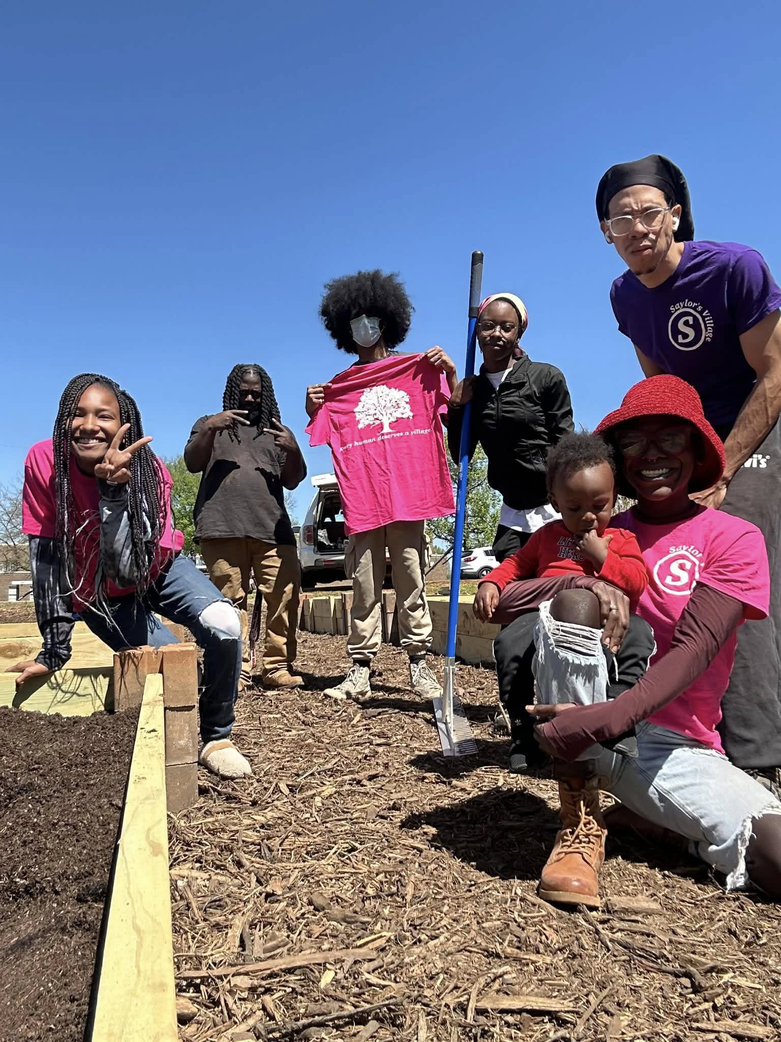 Say's Village community members building garden beds together